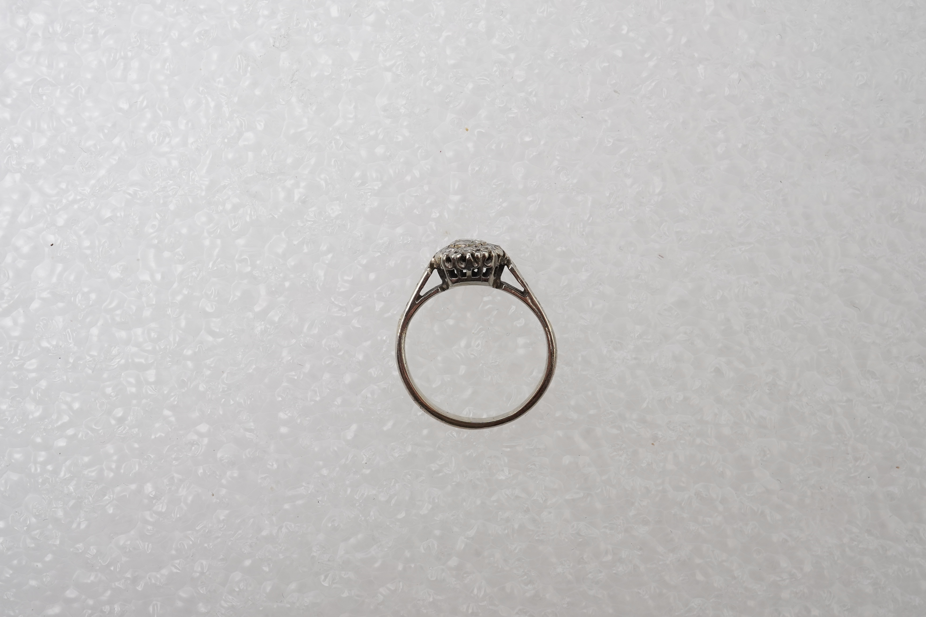 A diamond cluster ring, mid 20th century, set with a cluster of brilliant-cut diamonds totalling approximately 0.30 carats, mounted in unmarked white metal, size G, gross weight approximately 3 grams